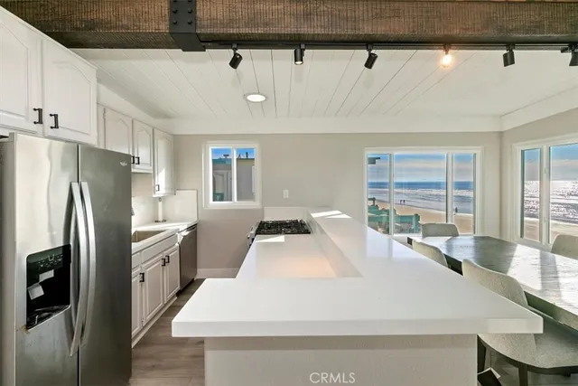 a large white kitchen with a large window