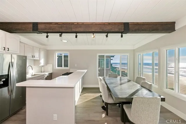 a kitchen with a table chairs and refrigerator