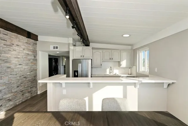 a kitchen with stainless steel appliances granite countertop a sink a stove and cabinets