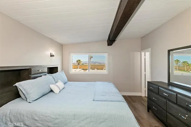 a view of a bedroom with furniture and flat screen tv