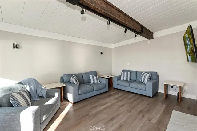 a living room with couches and a flat screen tv