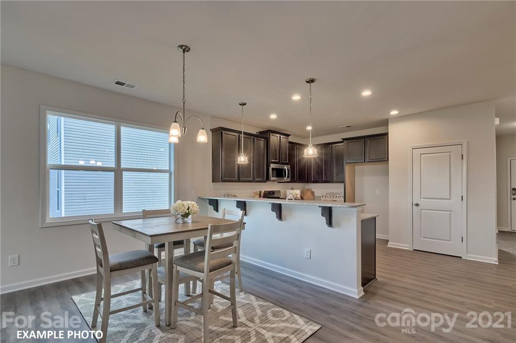 7396 Latham Way, Unit 5 Raleigh, NC 27604 - Photo 2 of 3 a kitchen with a table and chairs in it