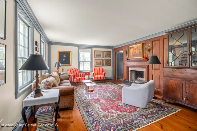 a living room with furniture a fireplace and a large window