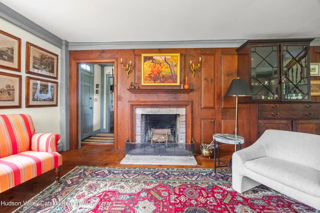 a living room with furniture a rug and a fireplace