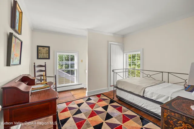 a bedroom with a bed and wooden cabinets
