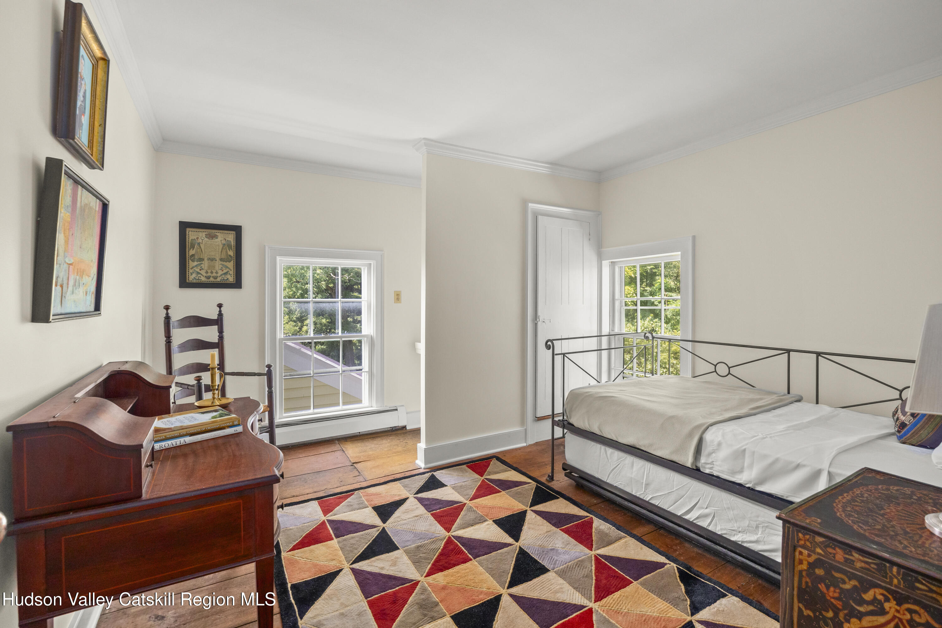 11549 Highway 22 Austerlitz, NY 12017 - Photo 16 of 28 a bedroom with a bed and wooden cabinets