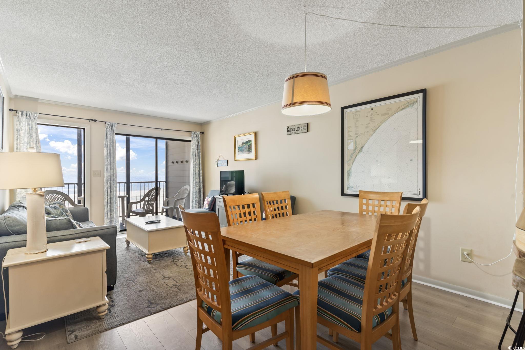 1780 North Waccamaw Drive, Unit 109 Murrells Inlet, SC 29576 - Photo 13 of 19 Dining room featuring a textured ceiling and wood finished floors