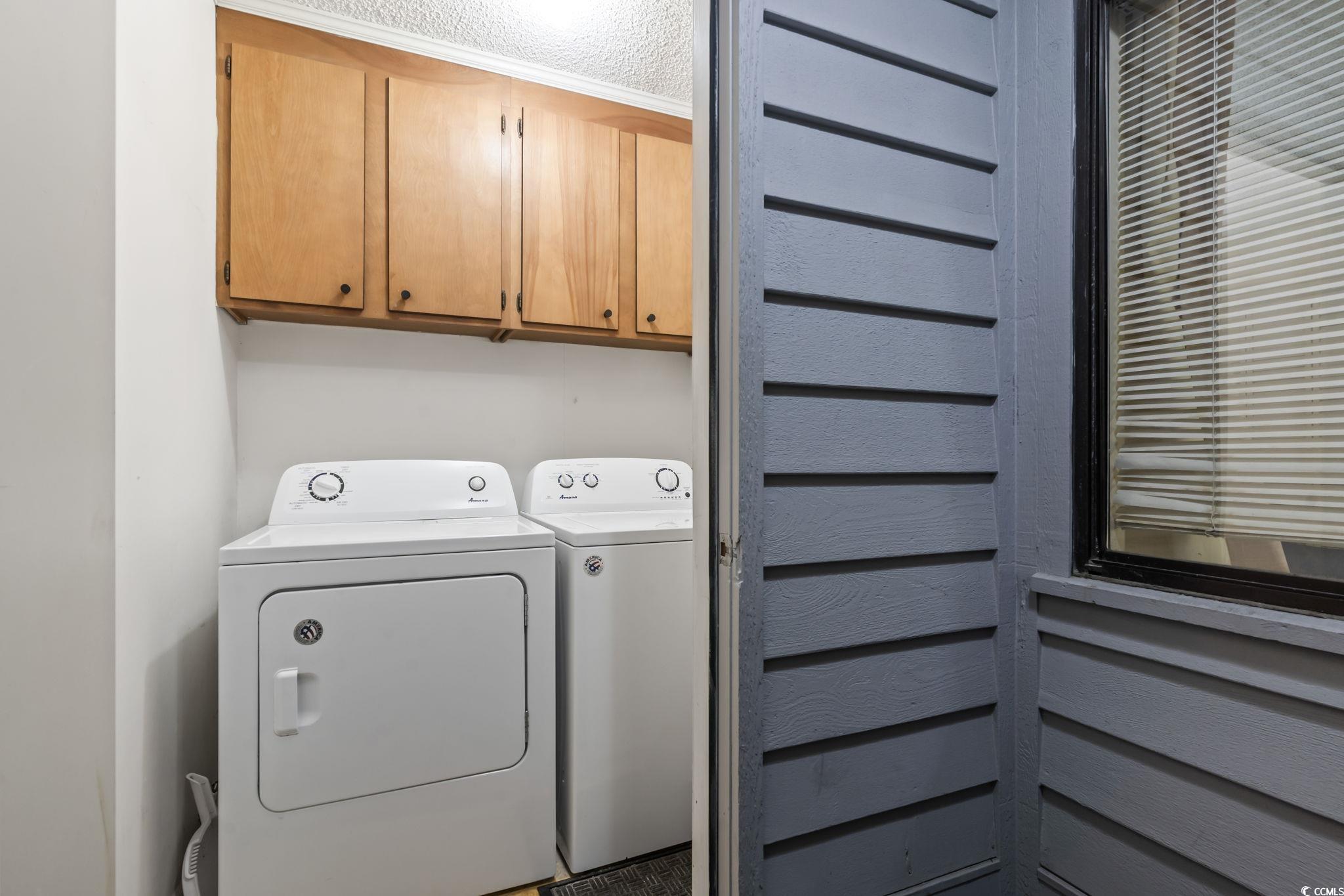 1780 North Waccamaw Drive, Unit 109 Murrells Inlet, SC 29576 - Photo 19 of 19 Laundry area featuring cabinet space, separate washer and dryer, and a textured ceiling