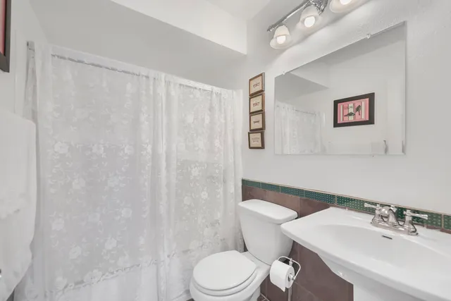 a white toilet sitting next to a bathroom sink