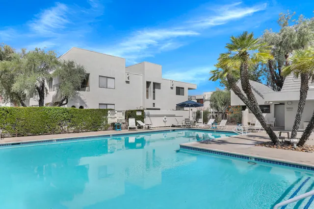a view of a house with backyard porch and sitting area