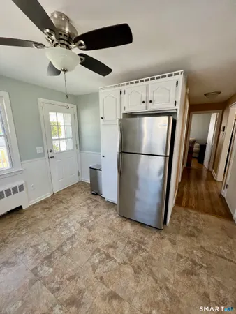 a kitchen with a refrigerator a microwave and cabinets
