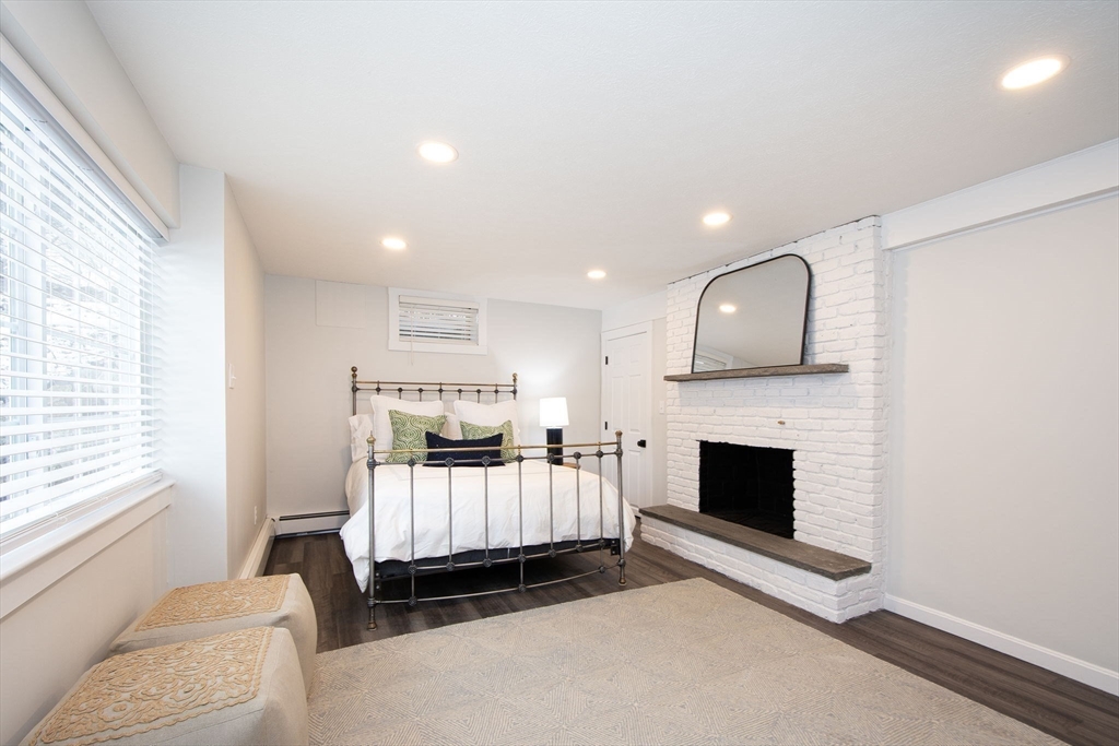 64 Cross Street Hingham, MA 02043 - Photo 17 of 23 a living room with furniture a fireplace and a window