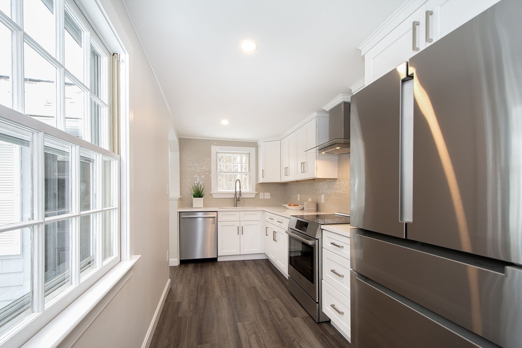 64 Cross Street Hingham, MA 02043 - Photo 8 of 23 a kitchen with stainless steel appliances a refrigerator sink and stove