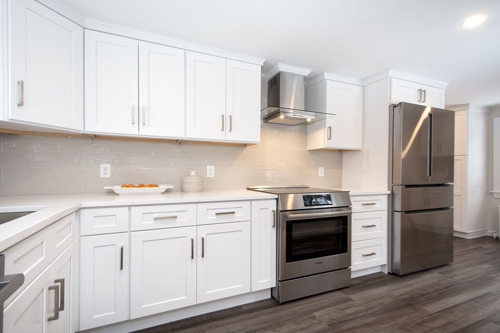 64 Cross Street Hingham, MA 02043 - Photo 9 of 23 a kitchen with white cabinets and stainless steel appliances