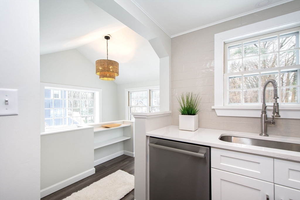64 Cross Street Hingham, MA 02043 - Photo 10 of 23 a kitchen with a sink a counter space and a window