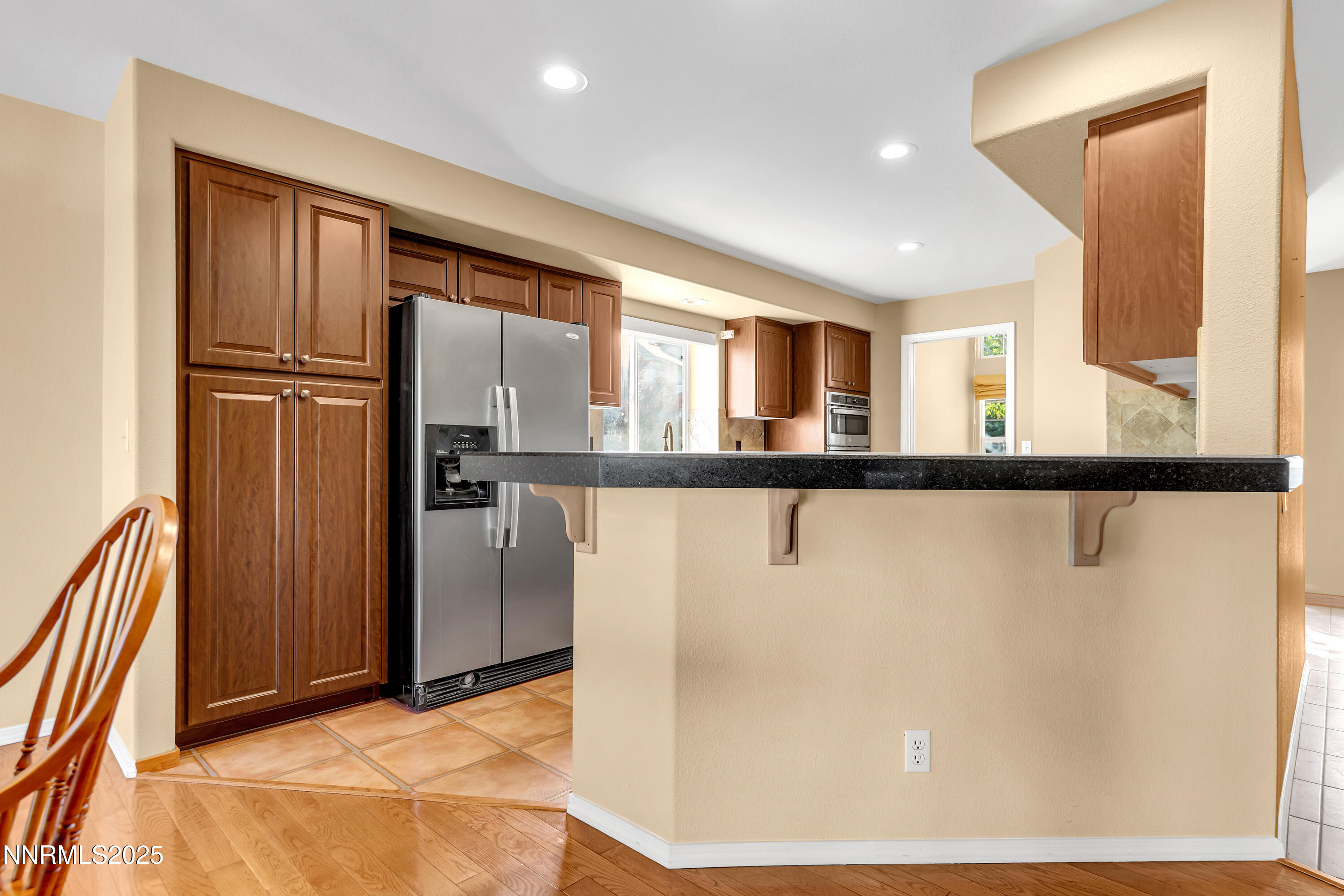 6248 Golden Meadow Road Reno, NV 89519 - Photo 17 of 64 a kitchen with granite countertop a refrigerator and a sink