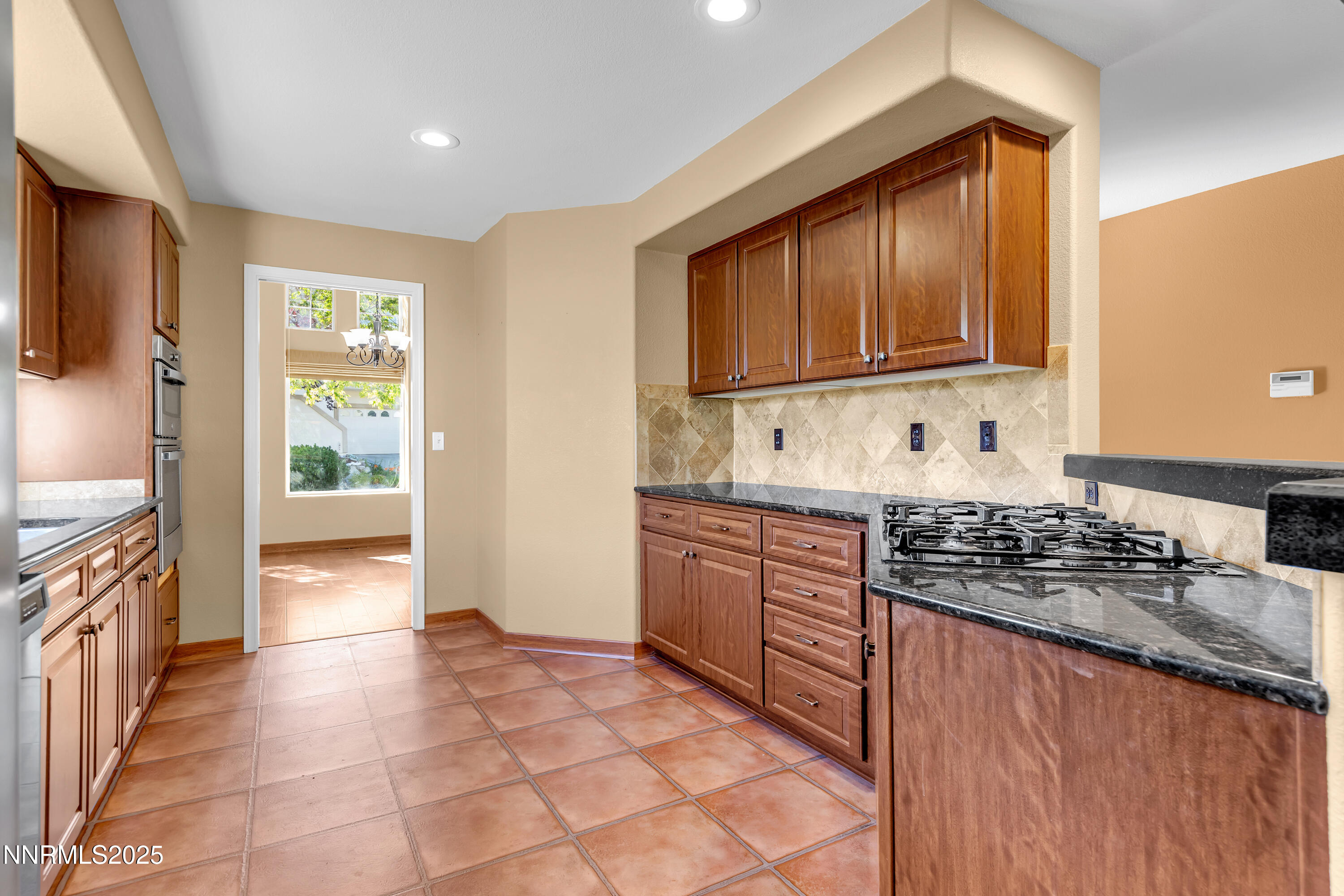 6248 Golden Meadow Road Reno, NV 89519 - Photo 18 of 64 a kitchen with stainless steel appliances granite countertop a stove a sink and a refrigerator