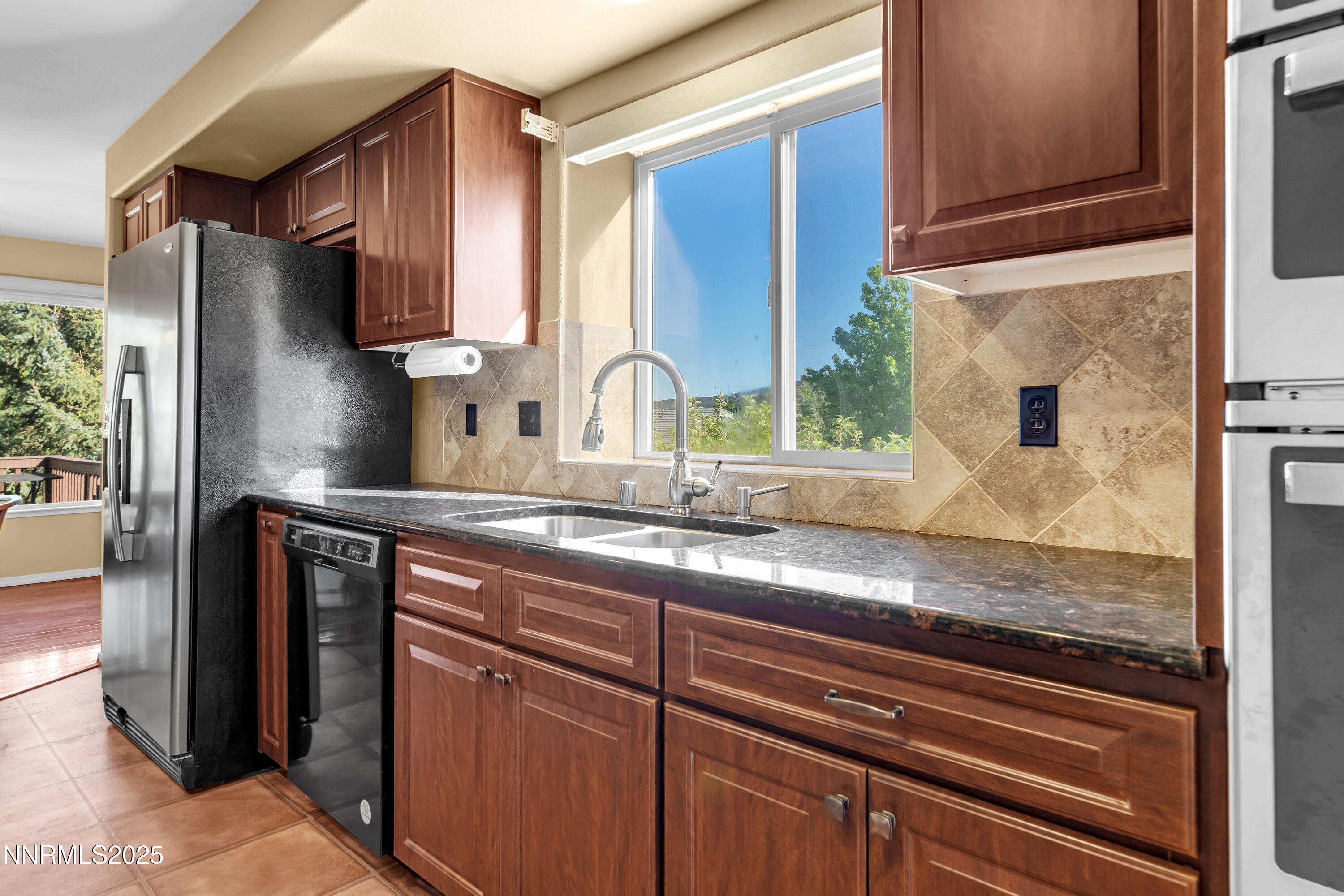 6248 Golden Meadow Road Reno, NV 89519 - Photo 20 of 64 a kitchen with granite countertop a sink stove and cabinets