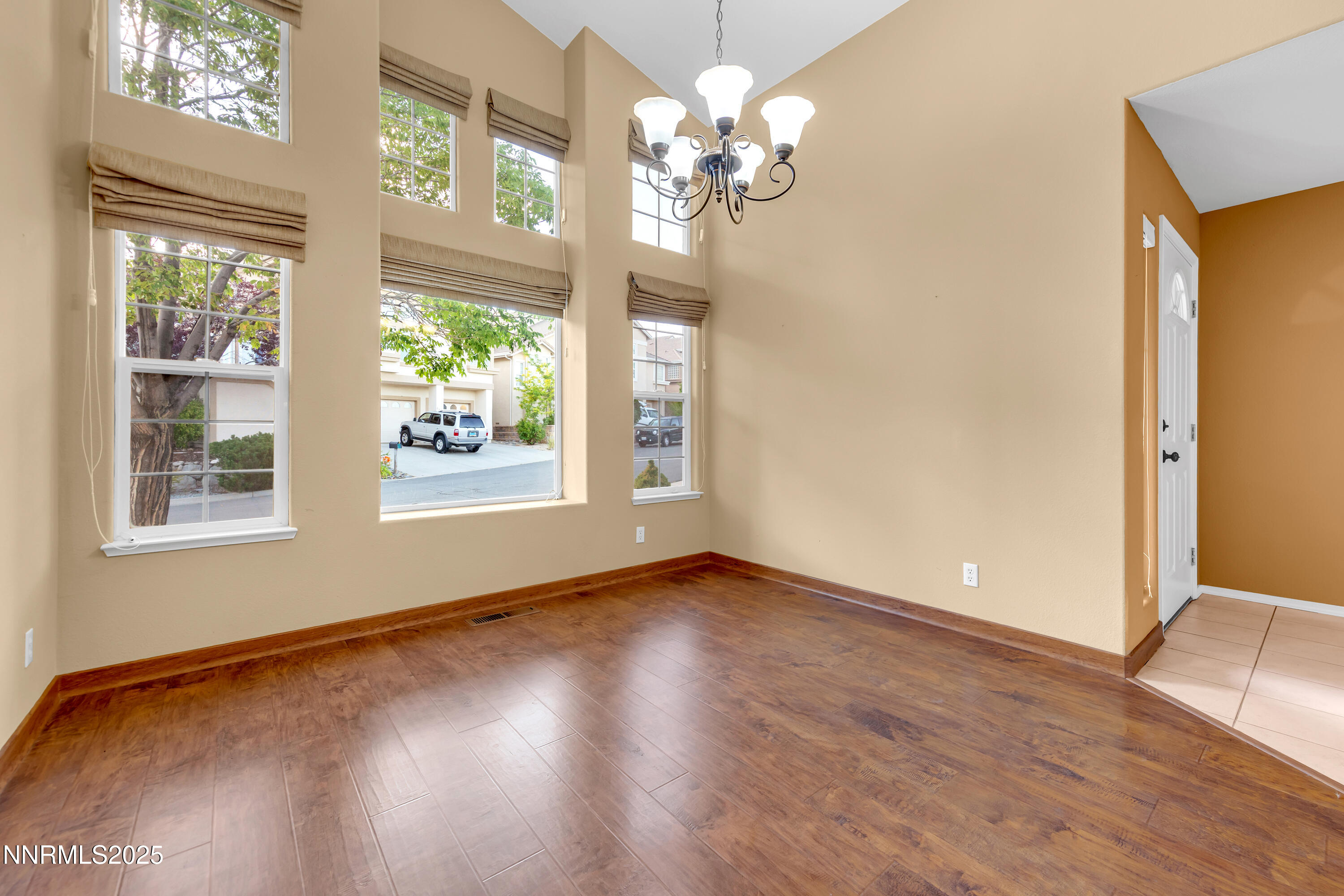 6248 Golden Meadow Road Reno, NV 89519 - Photo 7 of 64 a view of an empty room with wooden floor and a window