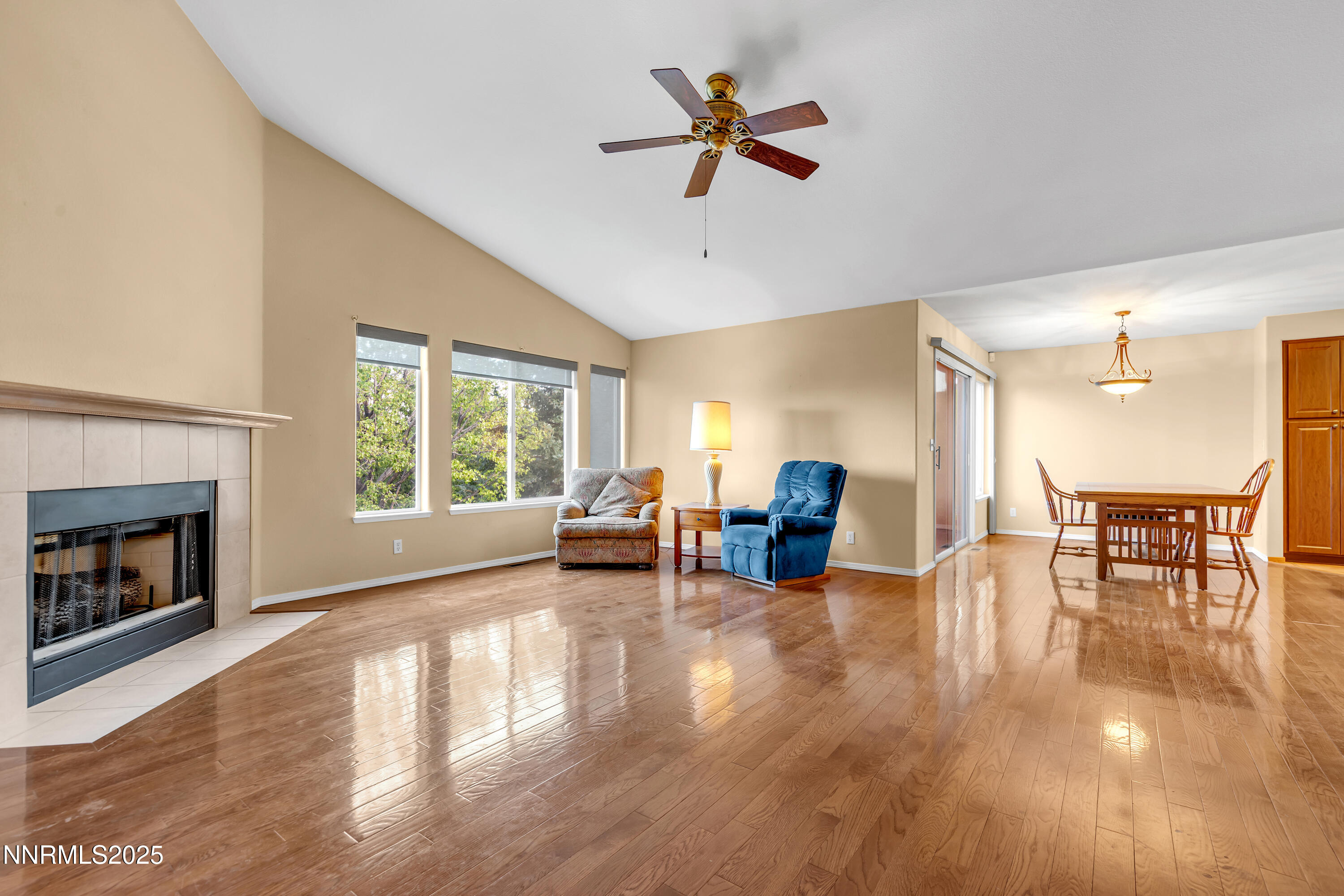 6248 Golden Meadow Road Reno, NV 89519 - Photo 9 of 64 a view of a livingroom with furniture a ceiling fan and a fireplace