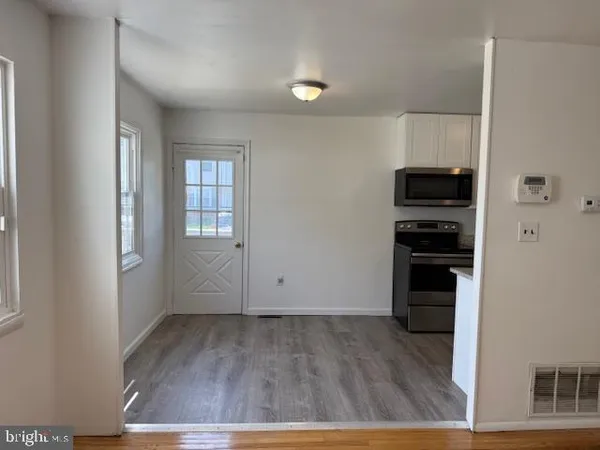 a view of kitchen and wooden floor