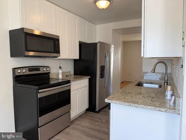 28 Keith Street Newark, DE 19713 - Photo 4 of 20 a kitchen with granite countertop wooden cabinets and stainless steel appliances