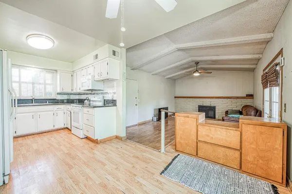 a kitchen with stainless steel appliances granite countertop a stove sink and cabinets
