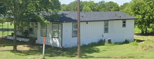 a view of house with a yard and a fountain