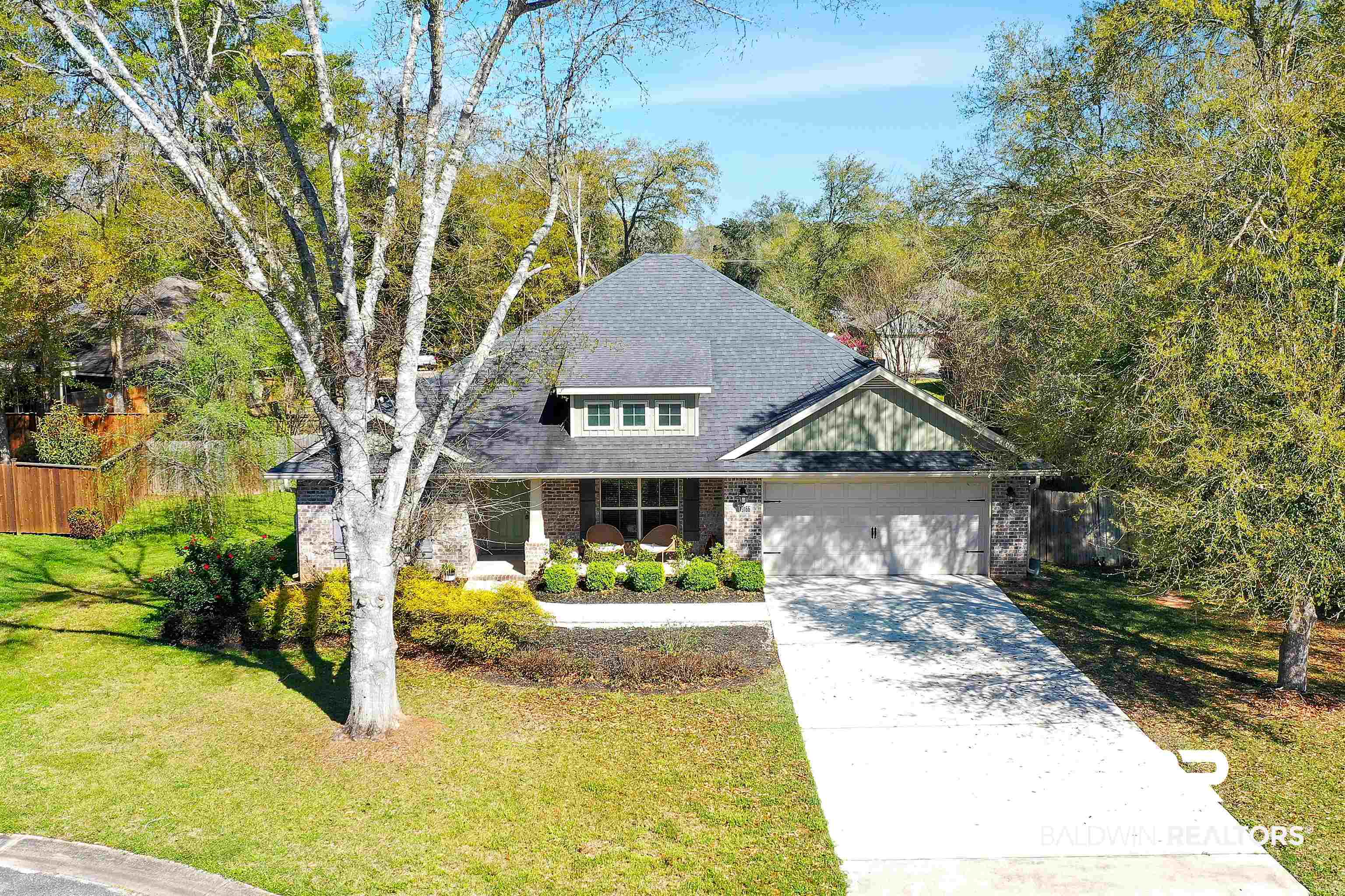 13166 Hulbert Court Foley, AL 36535 - Photo 1 of 27 View of front of home with roof with shingles, driveway, a front lawn, brick siding, and a garage
