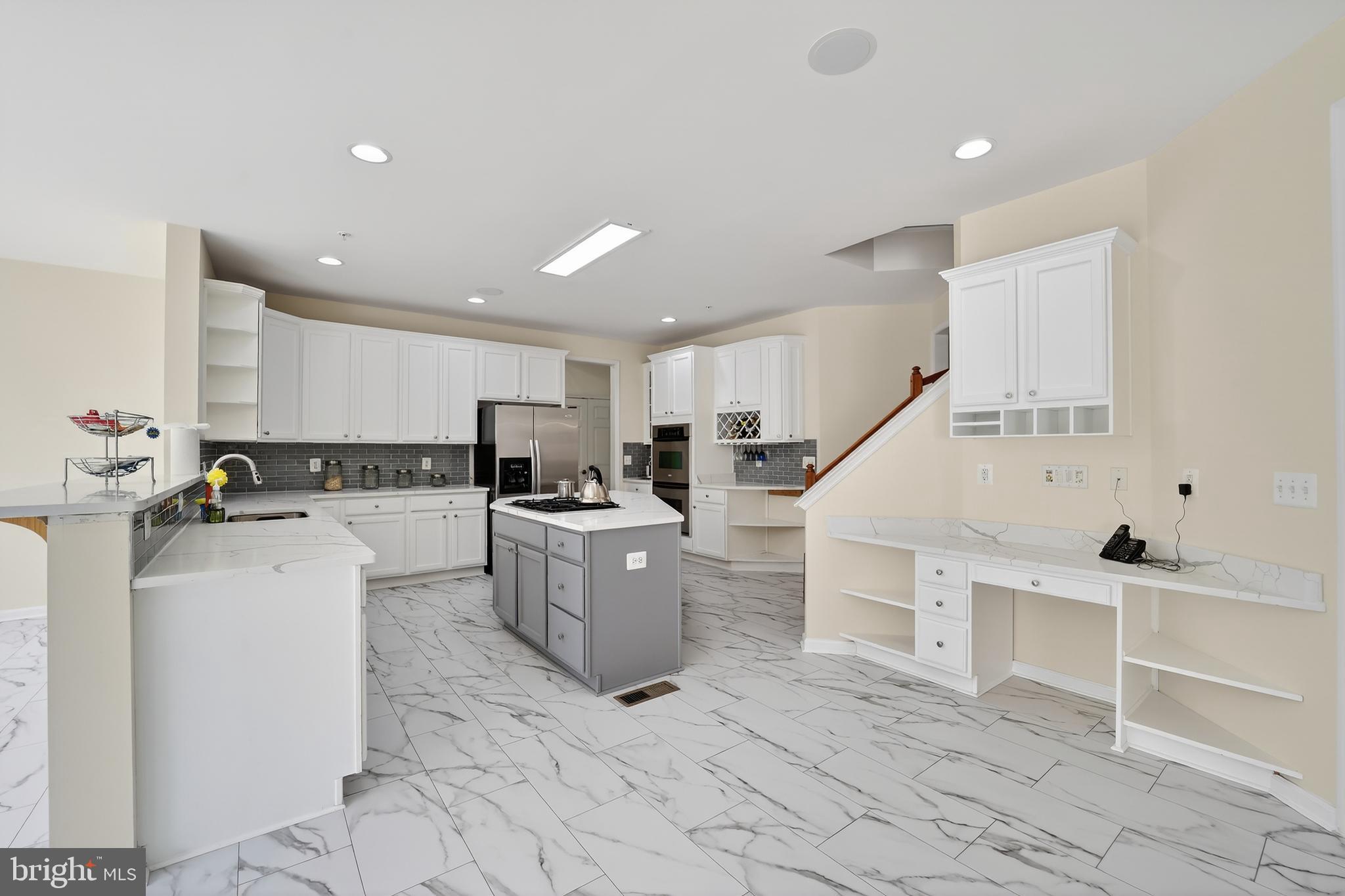 16101 Venice Road Aquasco, MD 20608 - Photo 15 of 60 a kitchen with white cabinets and white appliances