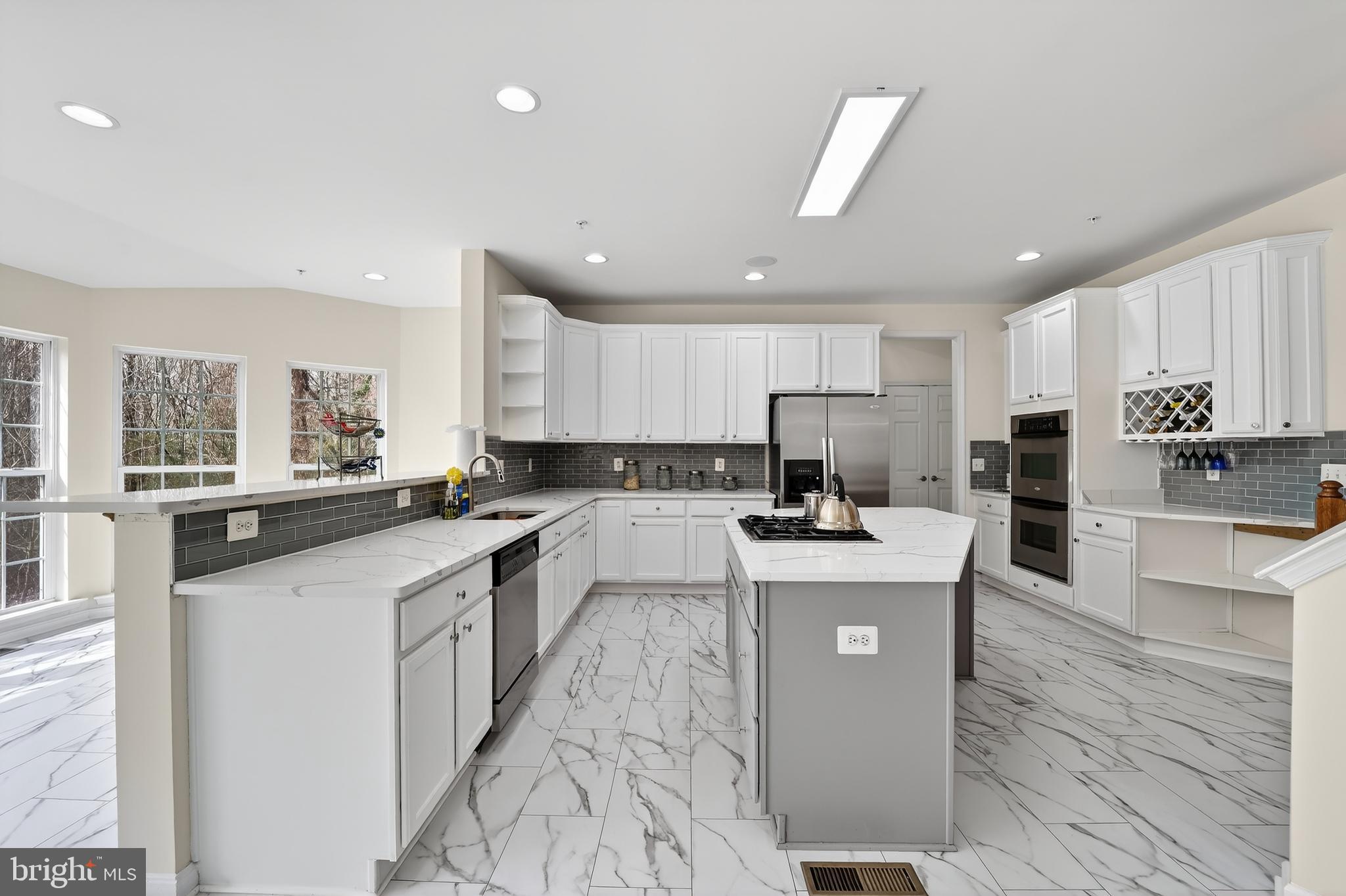 16101 Venice Road Aquasco, MD 20608 - Photo 16 of 60 a large kitchen with stainless steel appliances lots of counter top space