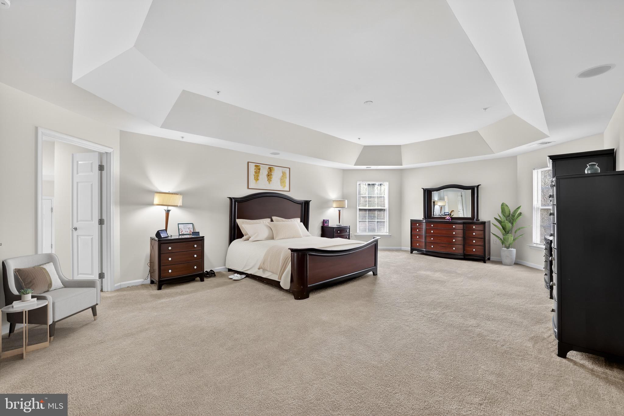 16101 Venice Road Aquasco, MD 20608 - Photo 34 of 60 a spacious bedroom with a bed and a couch