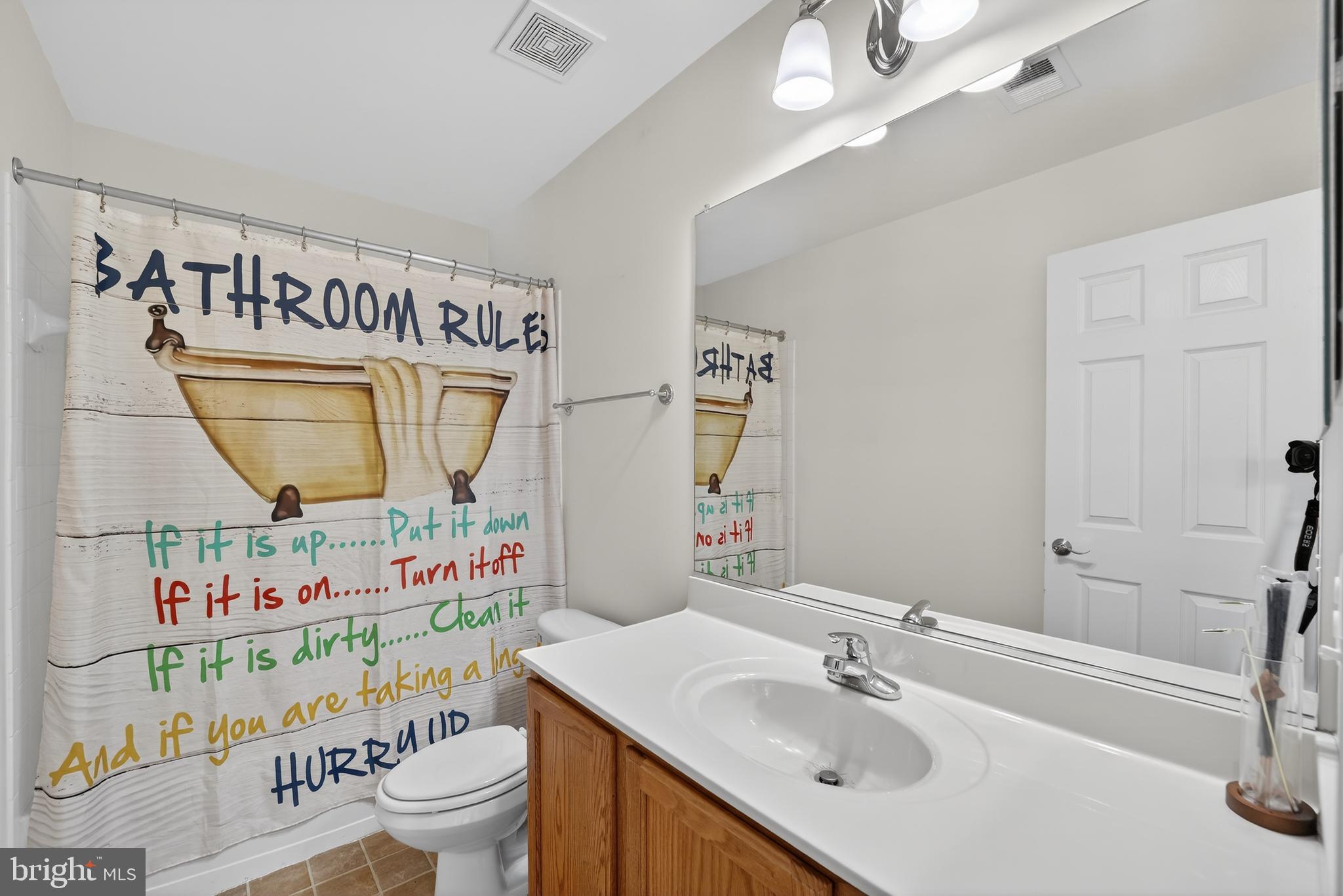 16101 Venice Road Aquasco, MD 20608 - Photo 46 of 60 a bathroom with a sink toilet and a mirror