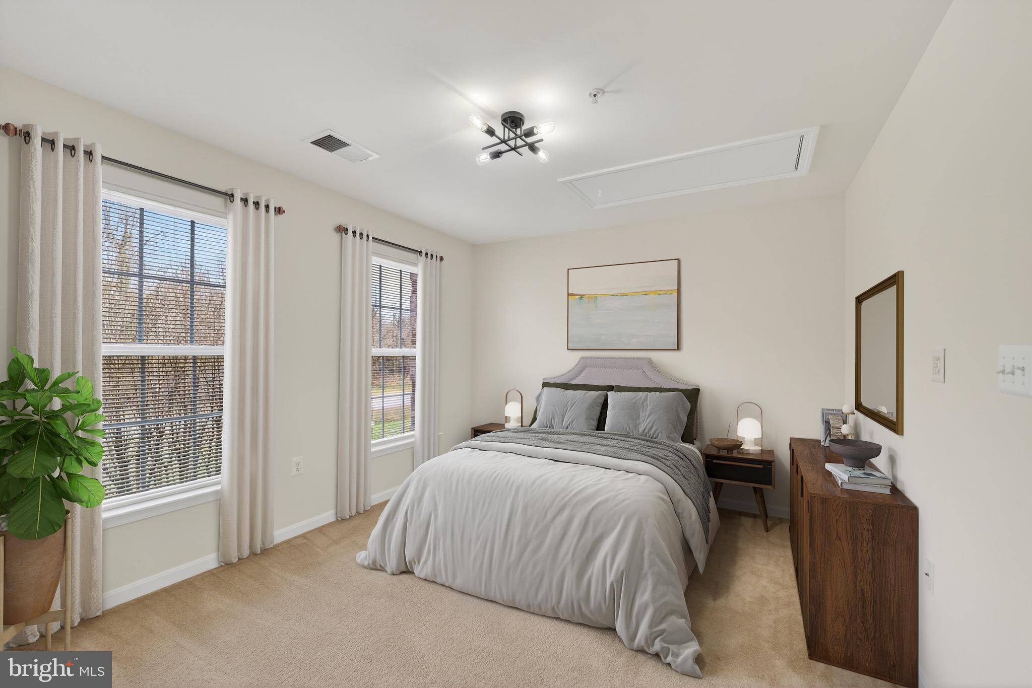 16101 Venice Road Aquasco, MD 20608 - Photo 47 of 60 a bedroom with a large bed and a chandelier fan