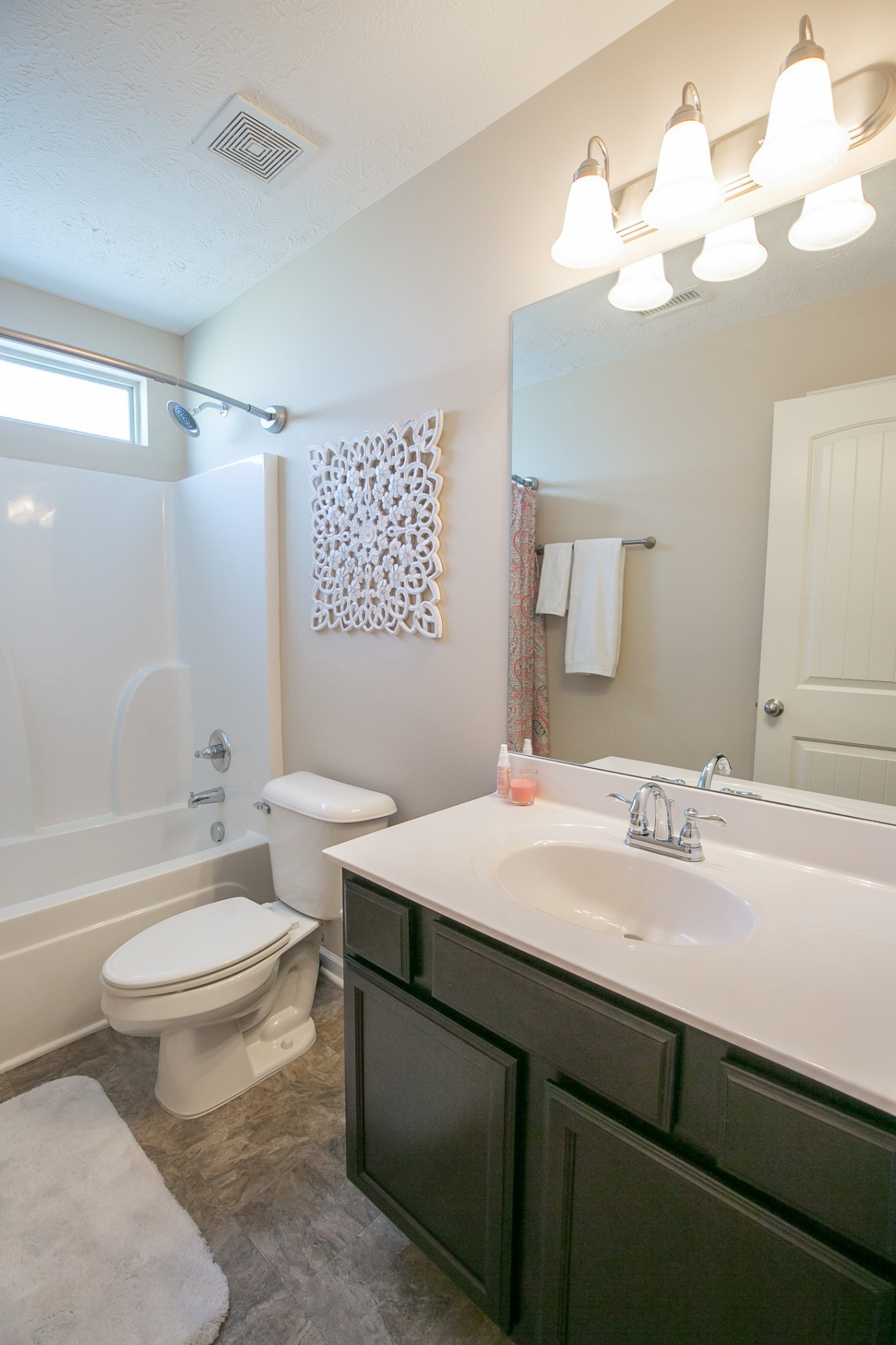 125 Copper Leaf Road Murfreesboro, TN 37128 - Photo 19 of 50 a bathroom with a sink a toilet a mirror a vanity and bathtub