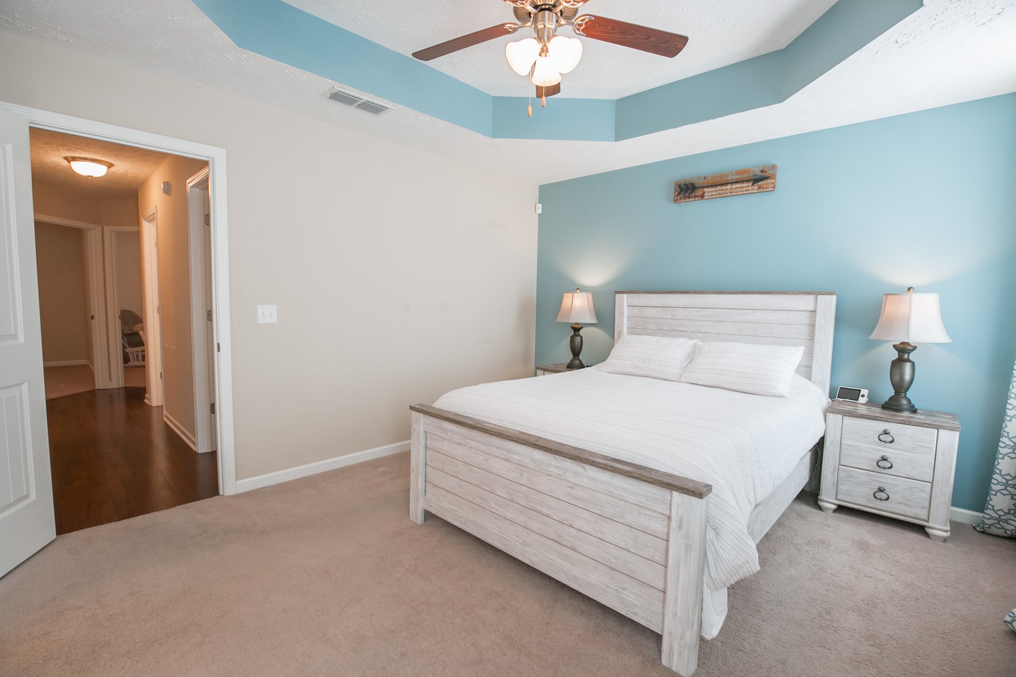 125 Copper Leaf Road Murfreesboro, TN 37128 - Photo 24 of 50 a bedroom with a bed and a chandelier