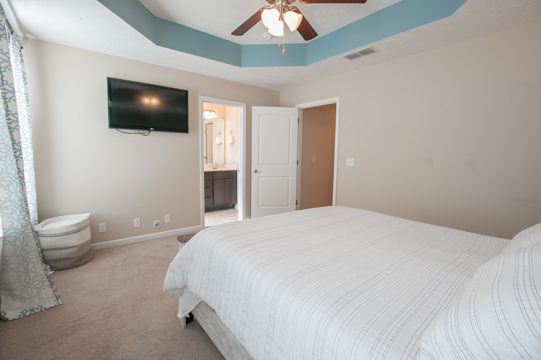 125 Copper Leaf Road Murfreesboro, TN 37128 - Photo 25 of 50 a bedroom with a bed and a flat screen tv
