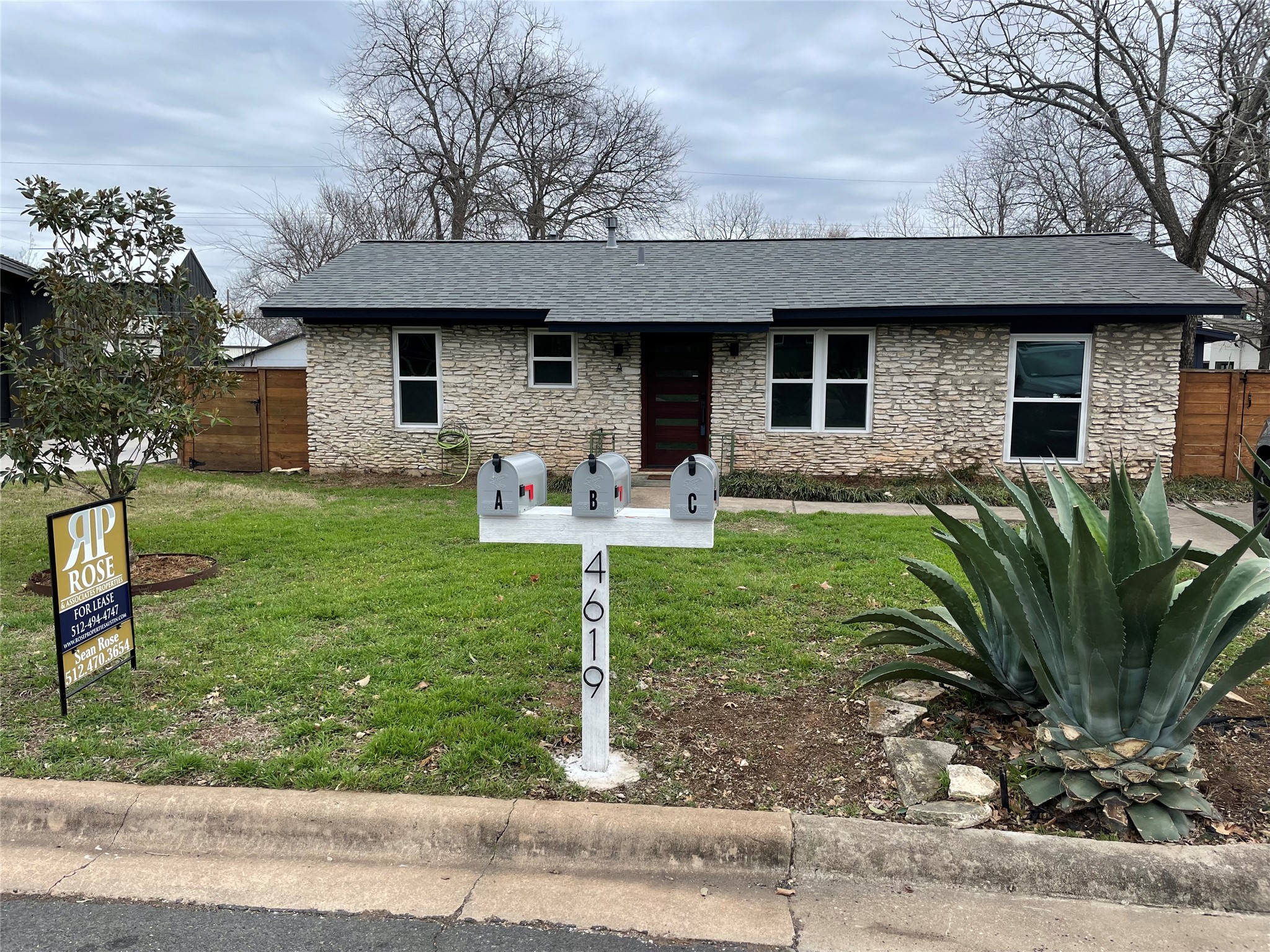 4619 Jinx Avenue, Unit A Austin, TX 78745 - Photo 14 of 21 Stone veneer exterior featuring a dark wood-finish entry door