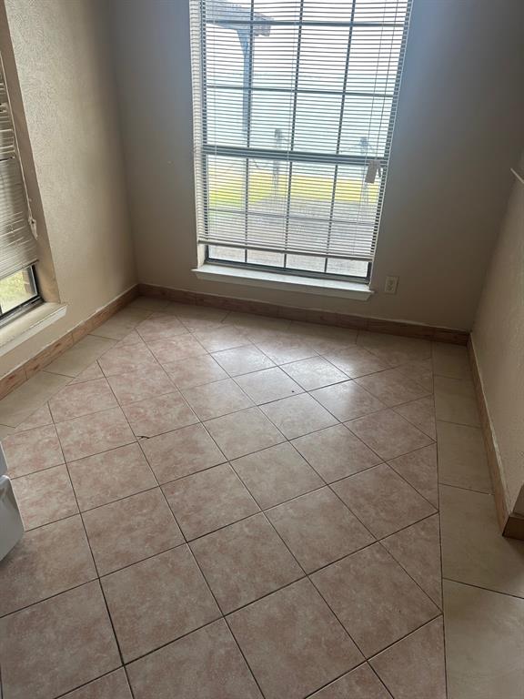 4610 Chaha Road, Unit 101 Garland, TX 75043 - Photo 11 of 18 an empty room with a window