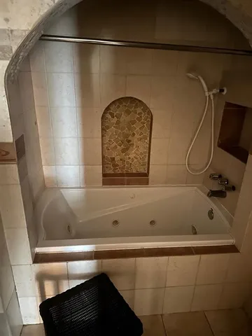 a bathroom with a tub and a shower
