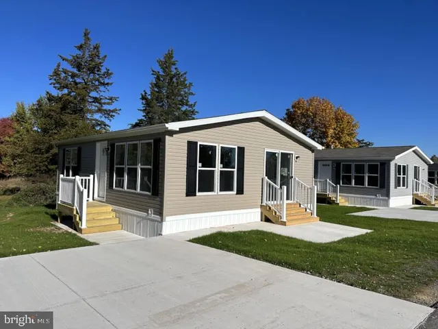 a front view of a house with a yard table and chairs