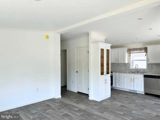 a view of a kitchen with wooden floor and electronic appliances