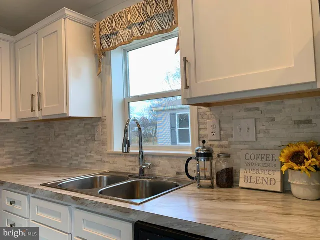 a kitchen with a sink and a window