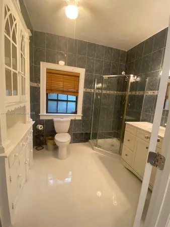 a view of a room with wooden floor and a window
