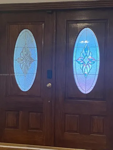 a living room with furniture a flat screen tv and a chandelier