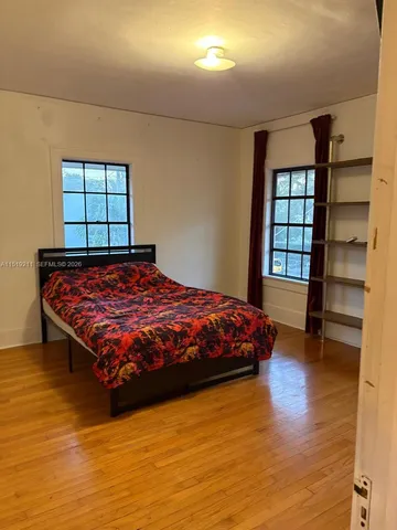 a view of a dining room with a table and chairs