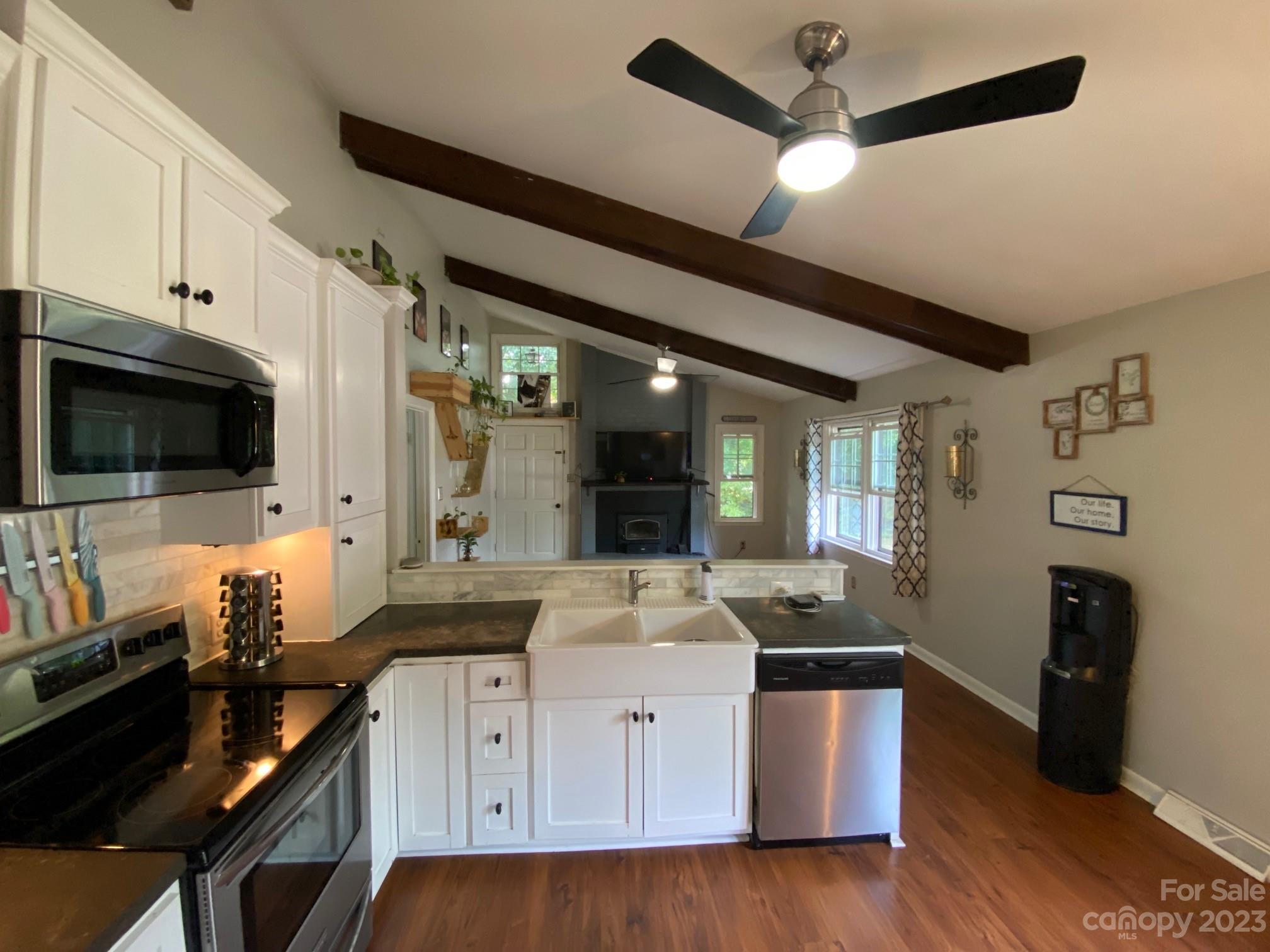 5901 Potter Road Matthews, NC 28104 - Photo 15 of 38 a kitchen with stainless steel appliances granite countertop a sink and a stove