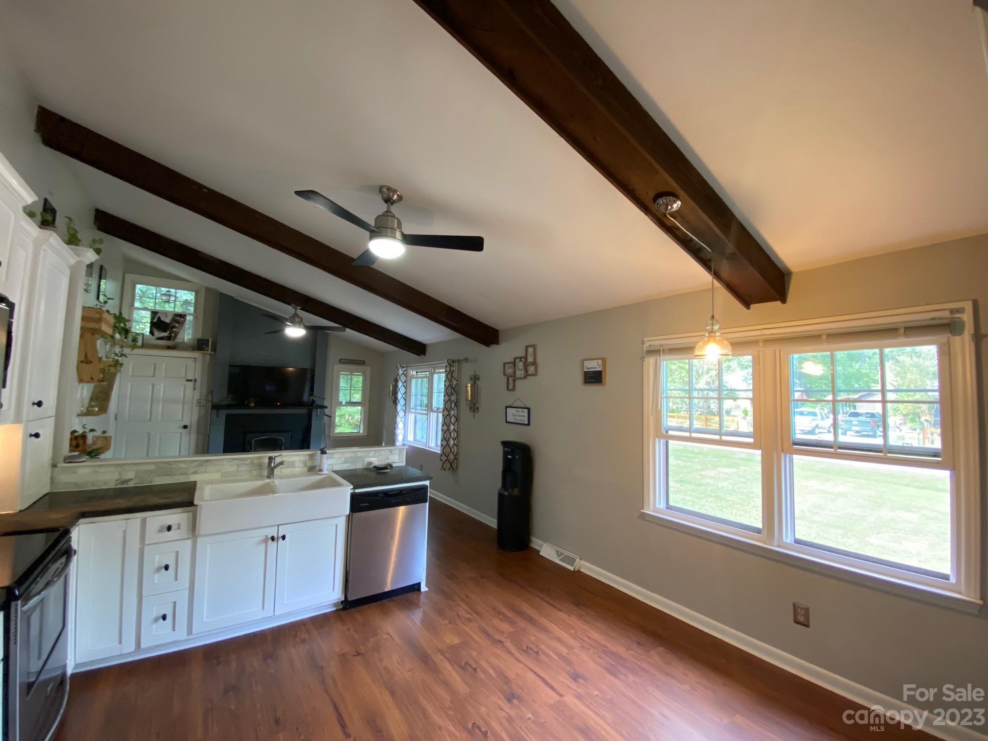 5901 Potter Road Matthews, NC 28104 - Photo 17 of 38 a large kitchen with stainless steel appliances kitchen island granite countertop a sink and wooden floors