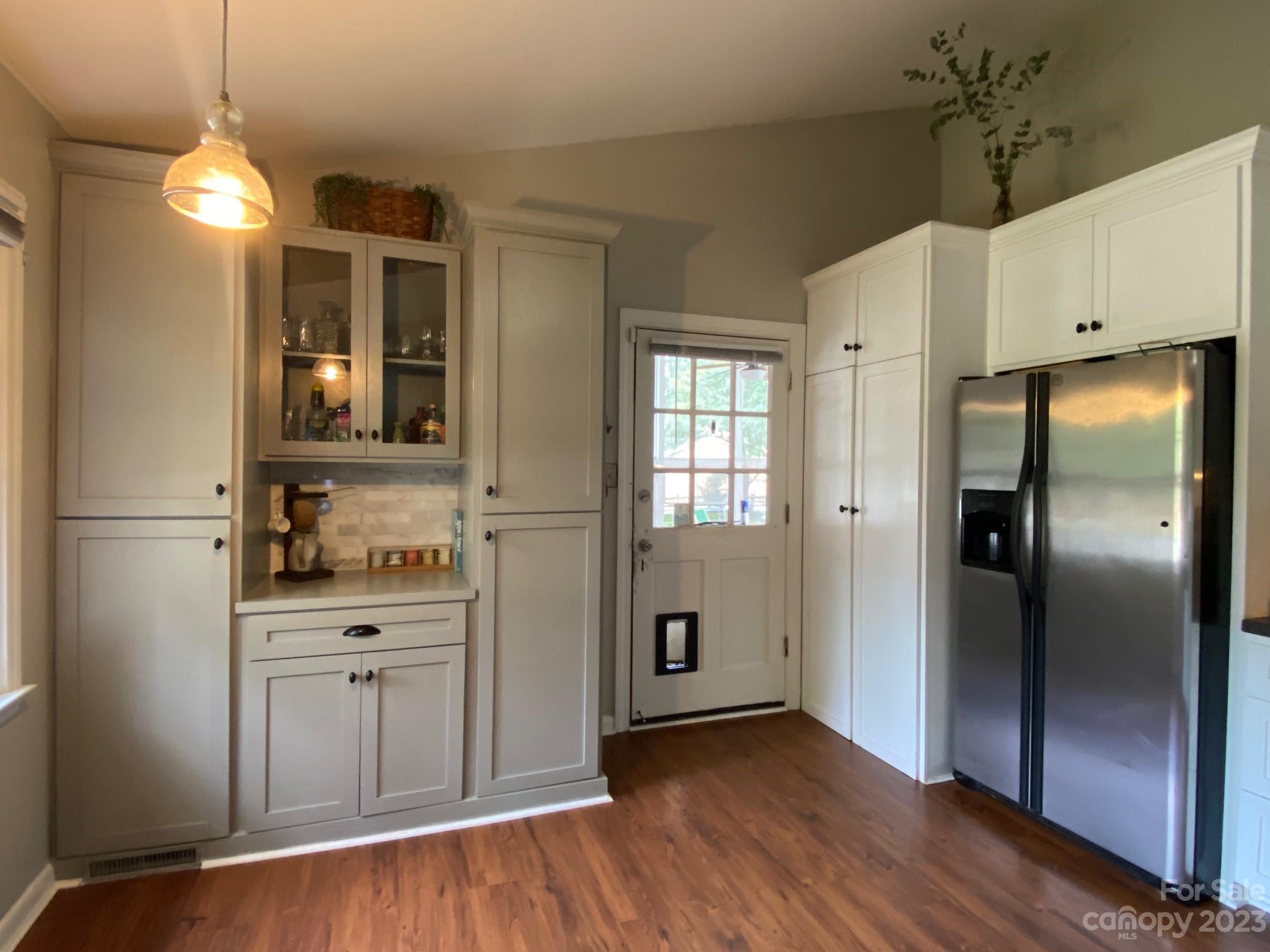 5901 Potter Road Matthews, NC 28104 - Photo 19 of 38 a kitchen with stainless steel appliances a refrigerator and wooden floor