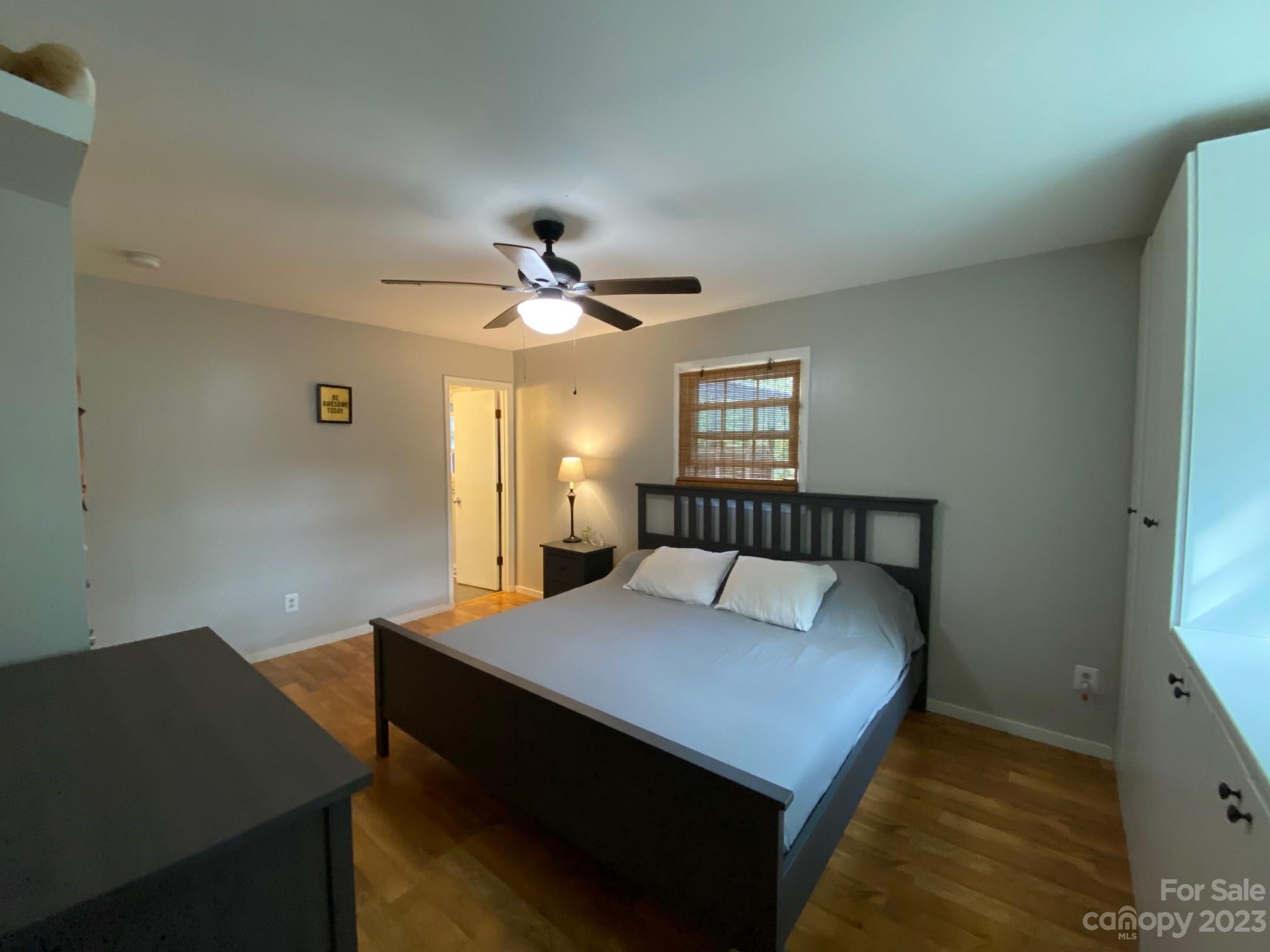 5901 Potter Road Matthews, NC 28104 - Photo 23 of 38 a bedroom with a bed and a chandelier